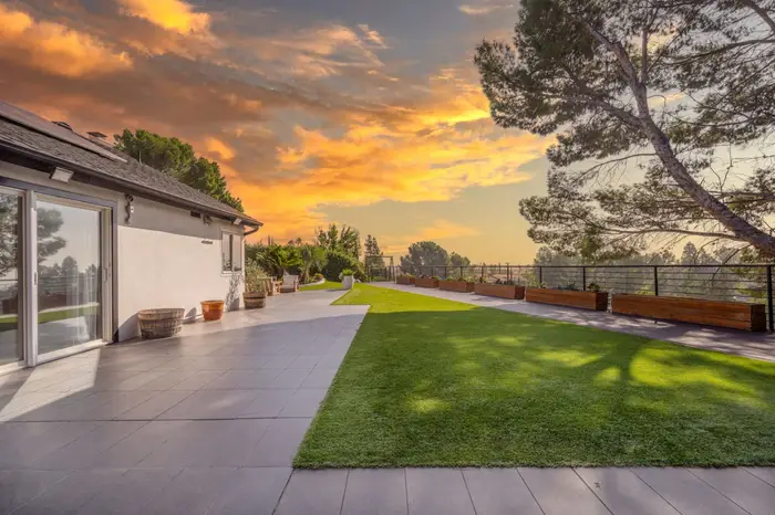 Terrace and lawn at Hills View, looking out over the valley at sunset