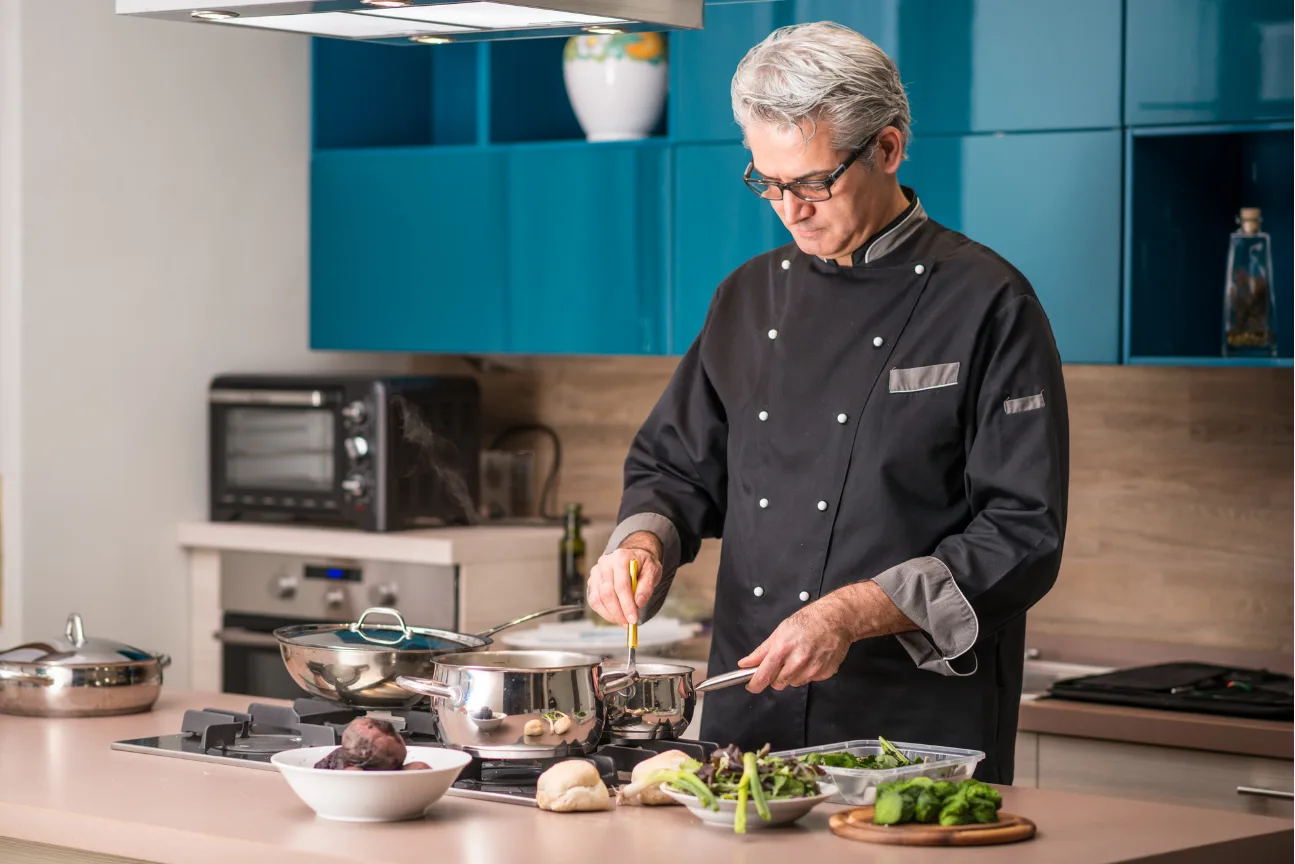 A private chef plating a course in the kitchen