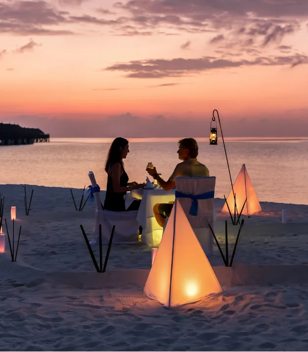 A dinner table set for two on the terrace